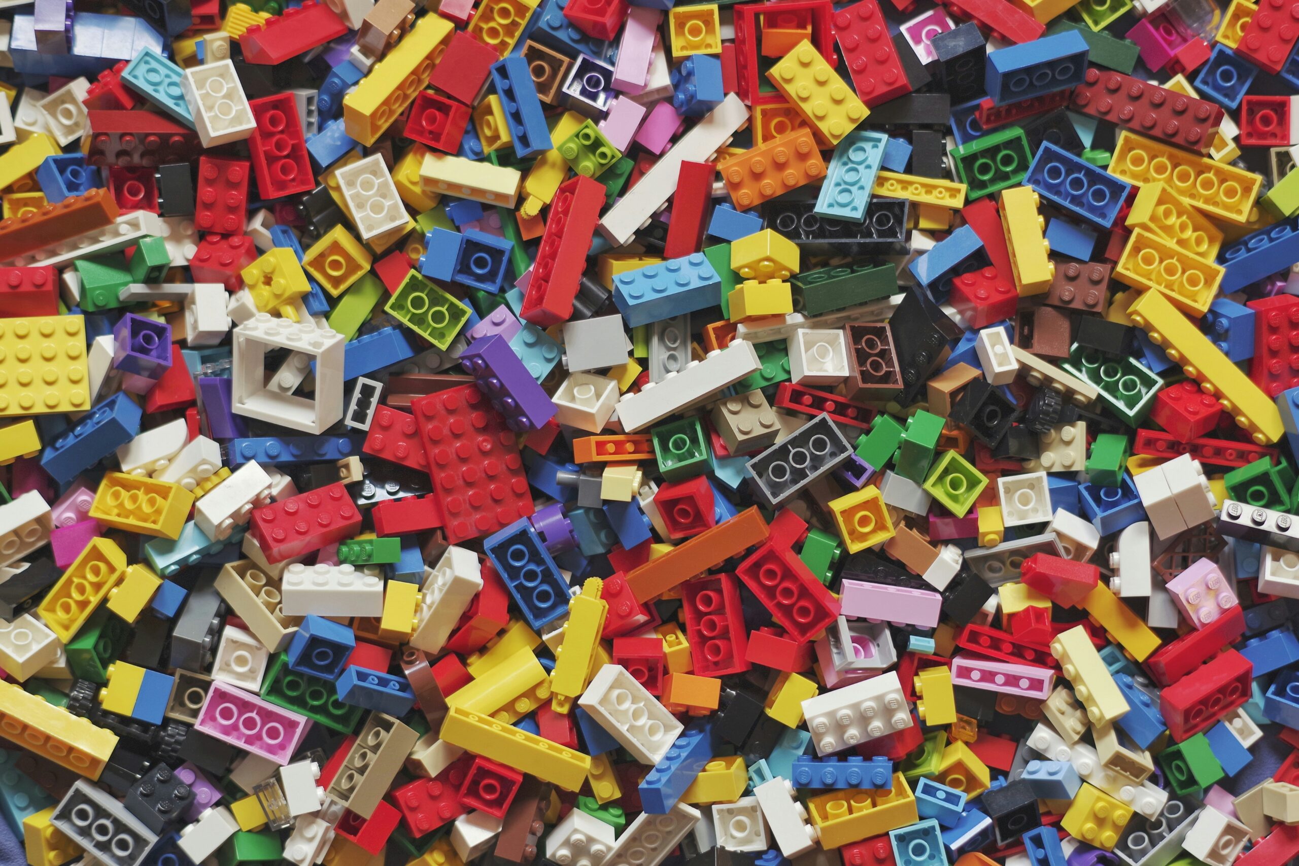 A pile of colorful LEGO bricks is shown. 